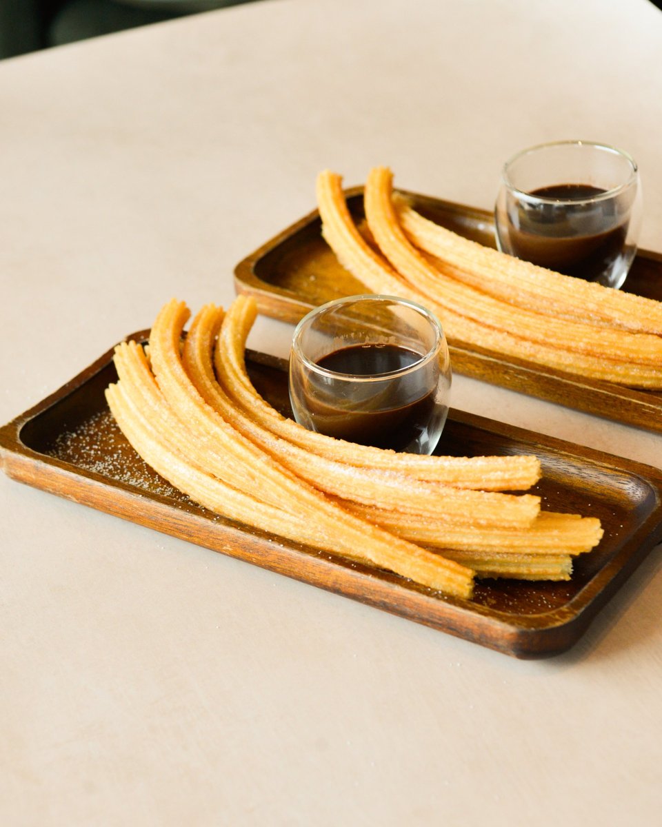 Churros on a wooden tray