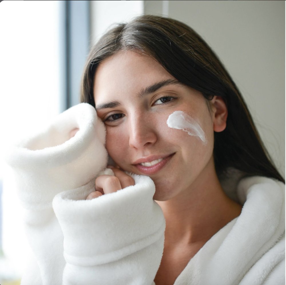 Girl with cream on her cheek